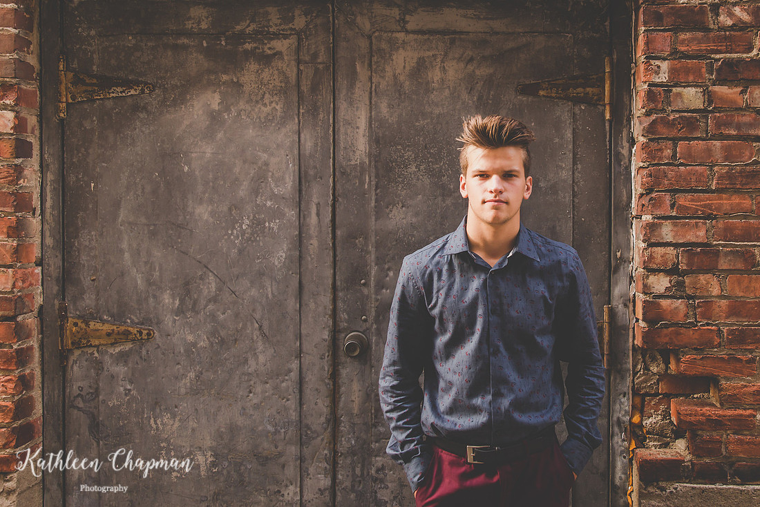 Senior guy in alley by cool door in Massena NY Potsdam NY family photographer