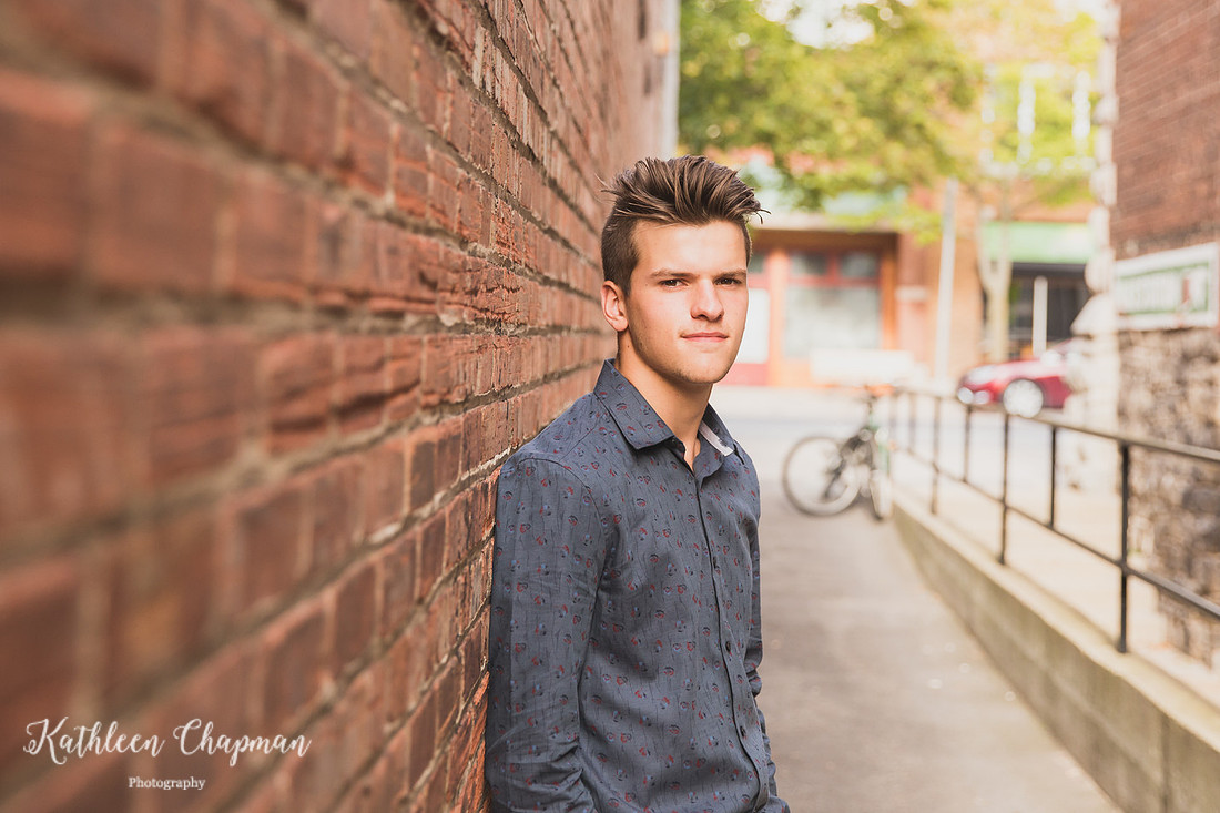 Senior guy in brick alley in Massena NY St. Lawrence County family photographer