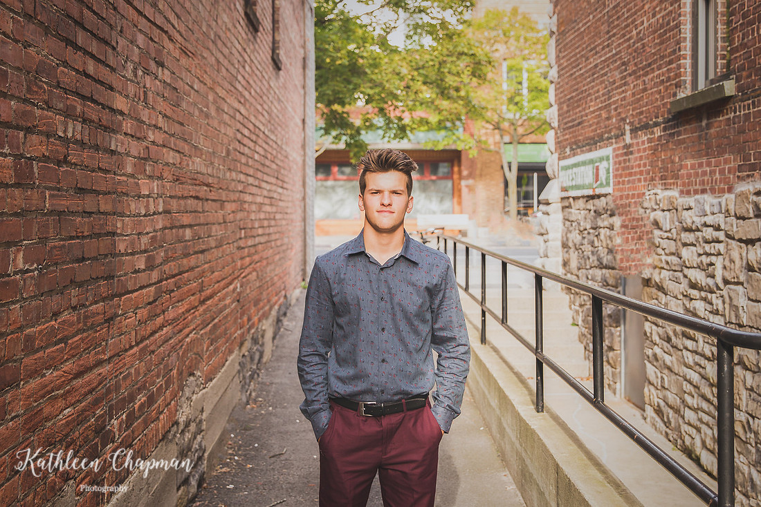 Senior guy in brick alley in Massena, NY St. Lawrence county family photographer