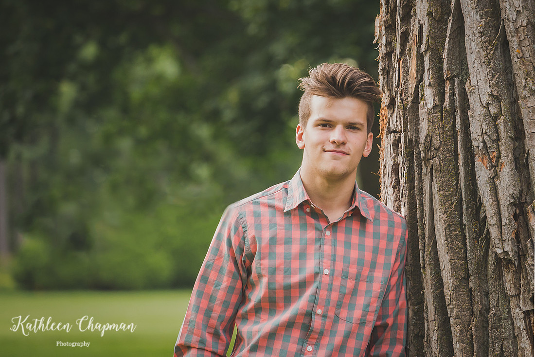 Senior boy in park by tree in Massena NY St. Lawrence county child photographer
