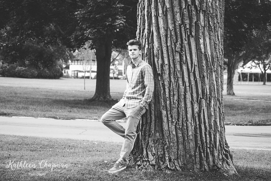 Black and white portrait of senior guy in park by big tree in Massena, NY Potsdam child photographer