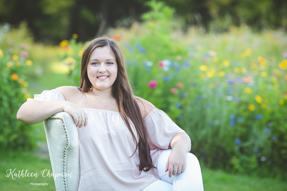 Senior girl in wild flower garden in chair Malone child photographer
