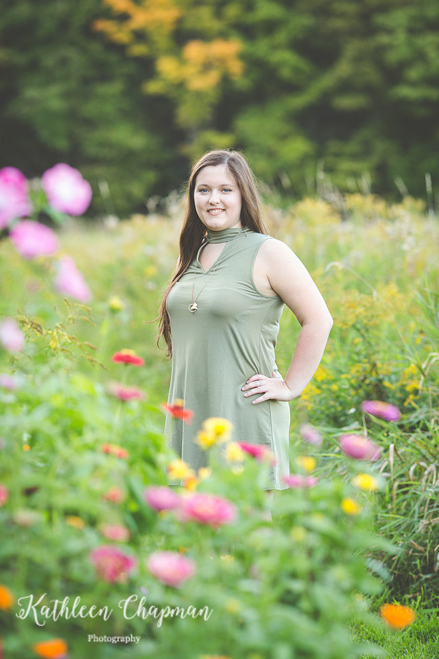 senior girl standing in wild flowers malone ny child photographer