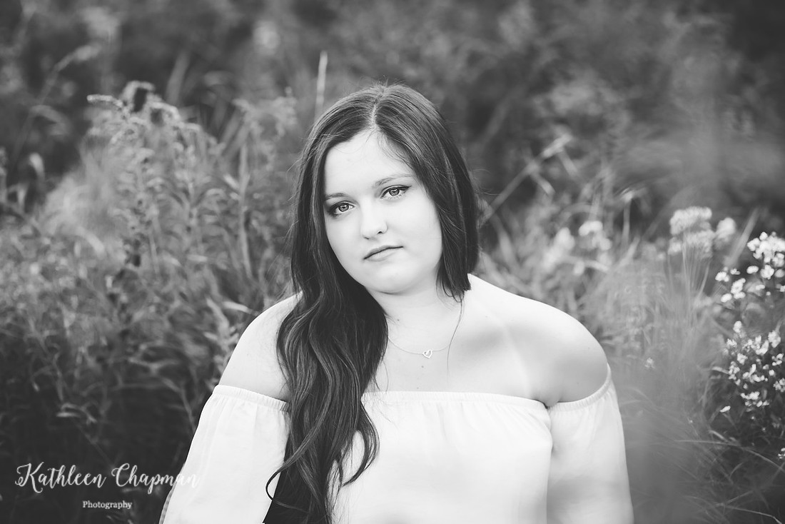 beautiful senior girl sitting in a field potsdam senior family photographer