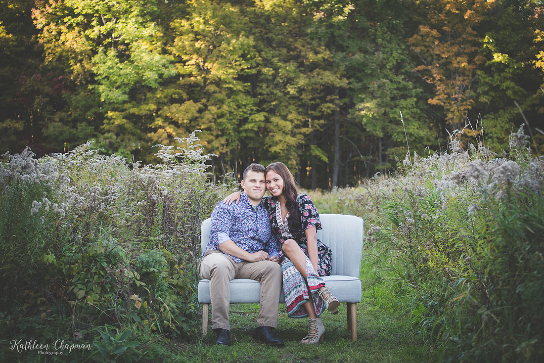 young couple snuggling on couch in field st. lawrence county ny child photographer