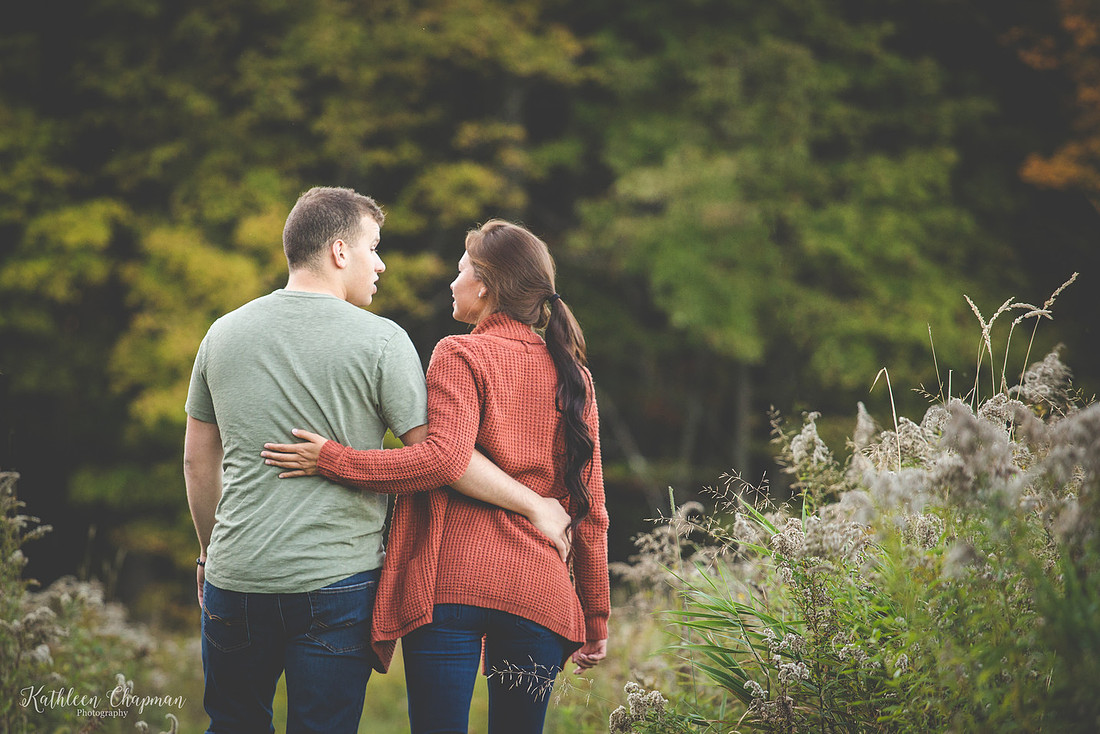 couple walking away in field north country family photographer