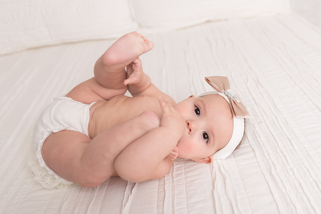 baby girl playing with toes franklin county ny family photographer